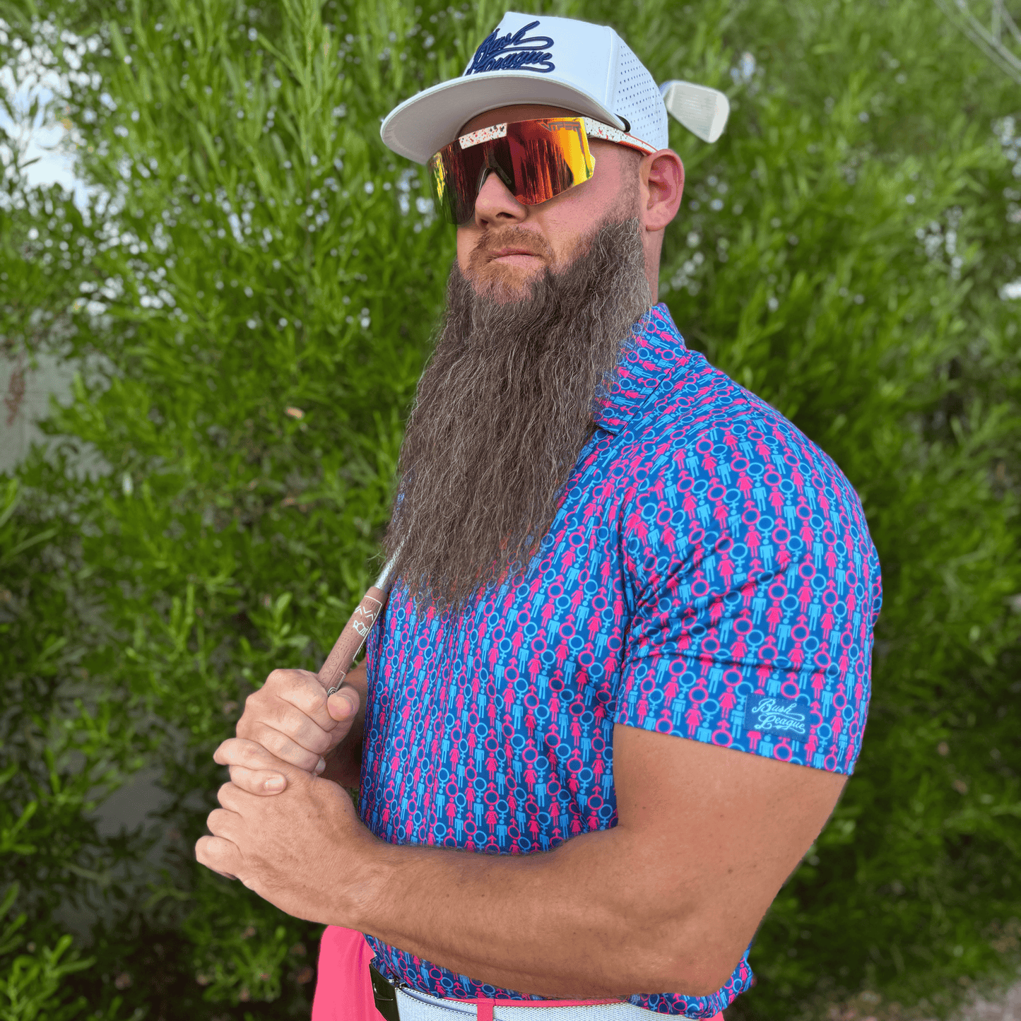 Men's Genders Golf shirt in blue and pink. Lifestyle image.