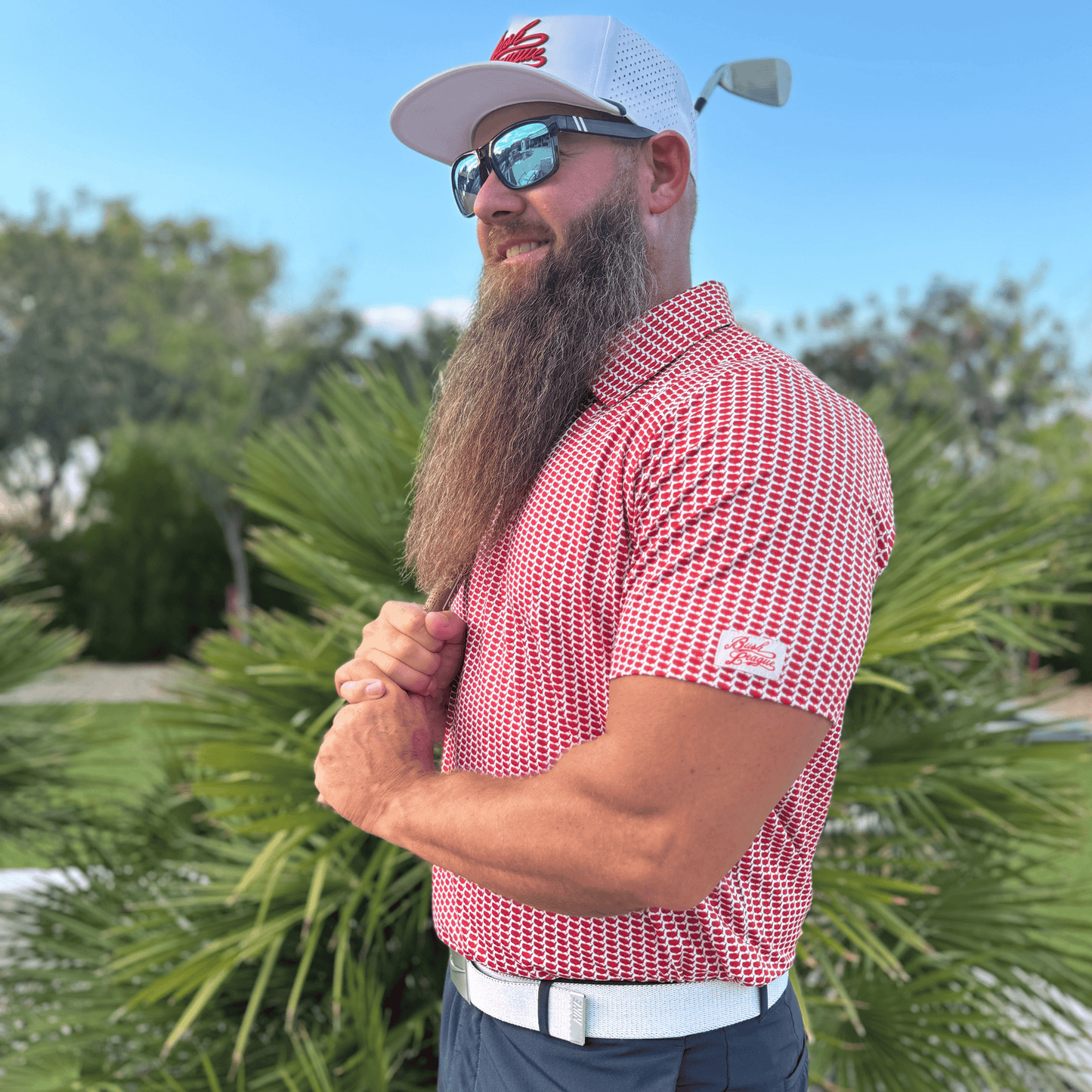 Men's Mandate Golf Shirt. Lifestyle photo. Model is wear size XL polo.