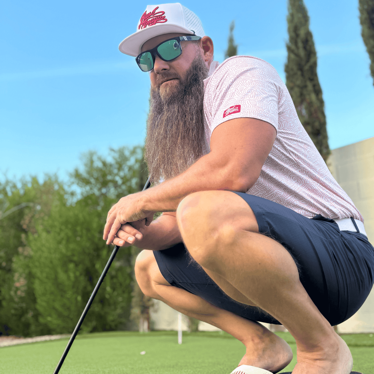 Men's Red Wave Golf Shirt. Lifestyle image.