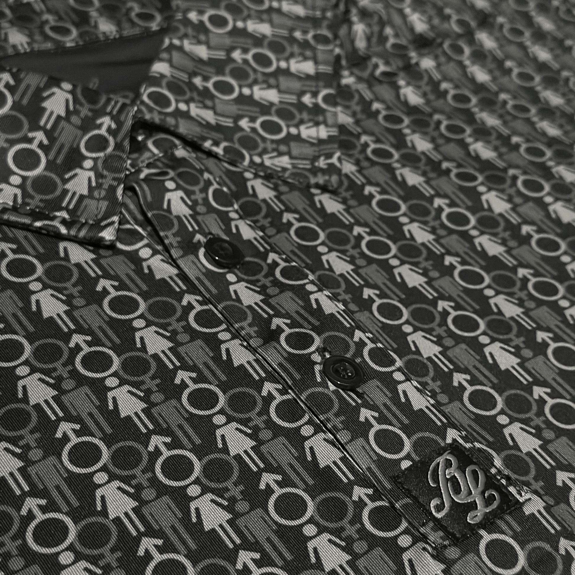 Men's 2 Genders Golf Shirt in black and grey. Close up of placket. 