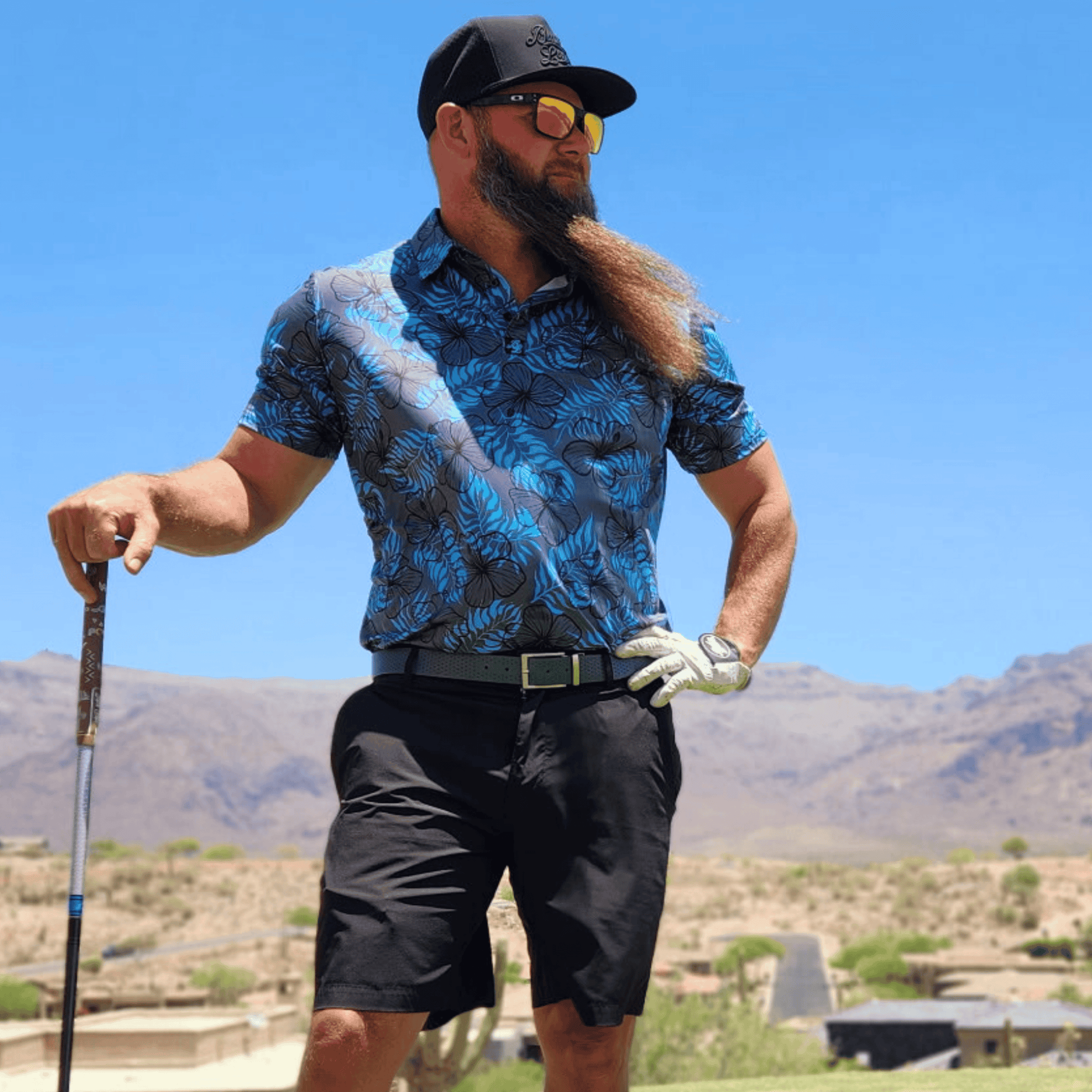 Men's Hibiscus Golf Shirt in grey and blue. Lifestyle image. 